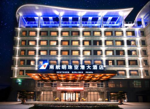 a building with blue lights on top of it at Guangzhou Southern Airlines Pearl Airport Hotel in Guangzhou