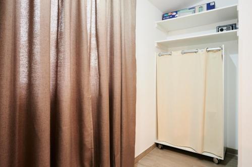 a brown shower curtain in a room with a wooden floor at Apartment Boris in Trogir