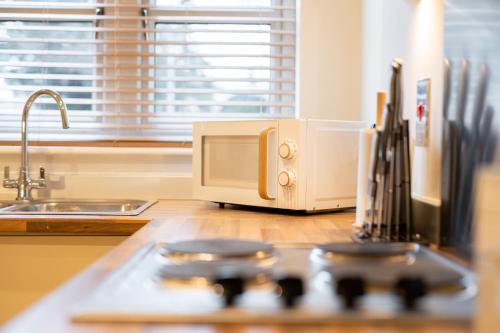 a kitchen counter with a toaster oven on top of a stove at Harmonious 2Bed Apartment-Suits Contractors in Leeds