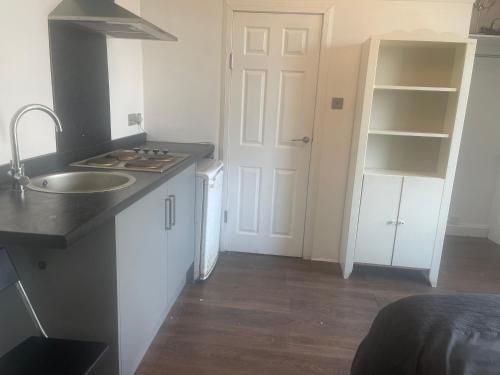 a kitchen with a sink and a counter top at ClydeView Apartments in Langbank