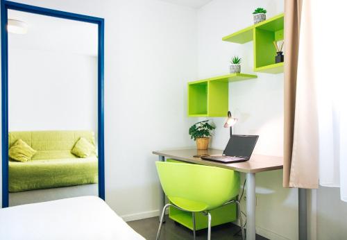 a bedroom with a desk with a laptop and a green chair at Twenty Business Flats Marseille Timone in Marseille