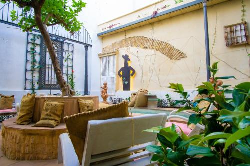 a living room with couches and a wall with a mural at Apartamentos Sharis in Jerez de la Frontera