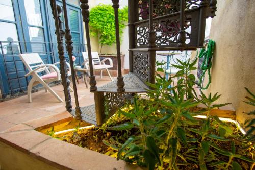 a balcony with a table and chairs and a plant at Apartamentos Sharis in Jerez de la Frontera