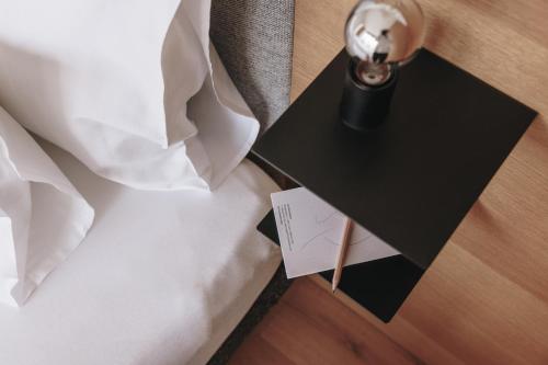 a close up of a table with a wedding dress and a candle at Hotel Schwarzschmied in Lana