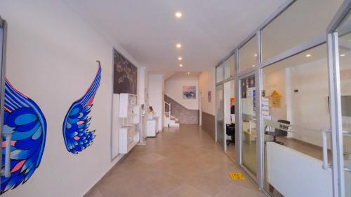 a hallway in a building with glass doors and a staircase at Mimosa Pension in Kaş