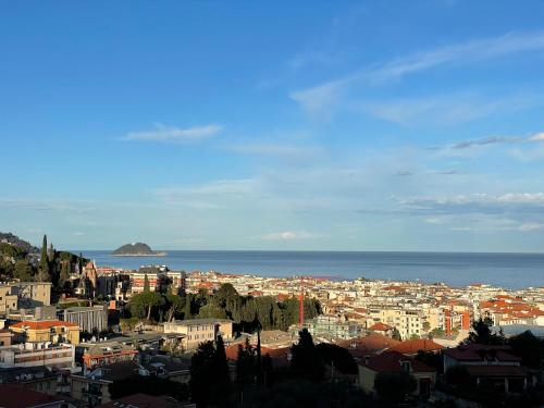 a view of a city with the ocean in the background at Holiday Rooms La Campagnetta in Alassio
