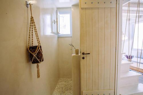 a hallway with a door and a purse on the wall at Santorita Suites in Akrotiri