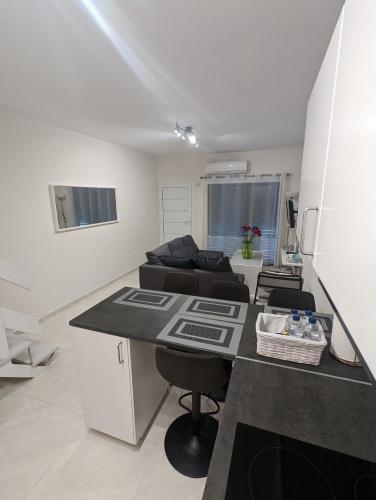 a kitchen and living room with a table and a couch at DreamIsland Maisonette Protaras in Paralimni