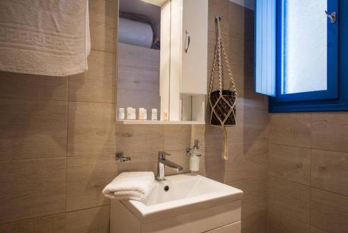 a bathroom with a sink and a mirror at Santorita Suites in Akrotiri