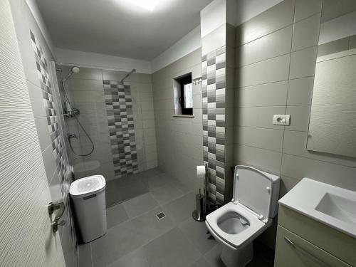 a bathroom with a toilet and a sink at MG Mamaia North Villa in Mamaia Sat/Năvodari