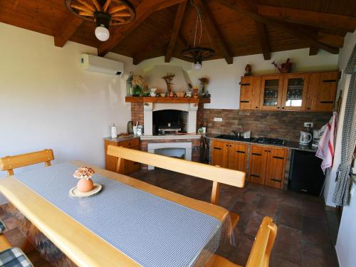 a kitchen with a table and a dining room at Holiday Home, Apartment and Rooms Milica in Mošćenička Draga