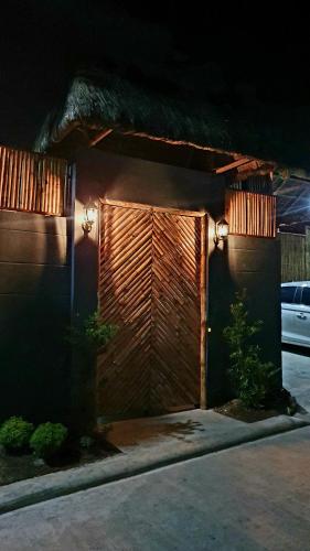 a garage with a wooden door with lights on it at The Farm Shack by SMS Hospitality in Amadeo