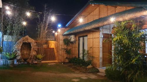 a house at night with lights in the yard at The Farm Shack by SMS Hospitality in Amadeo