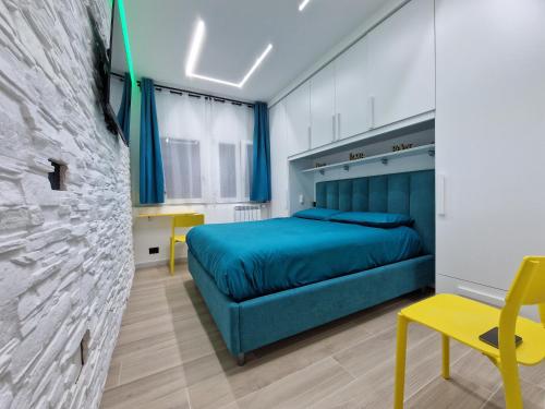 um quarto com uma cama azul e uma cadeira amarela em LA CASA DI TIAGO em Palermo