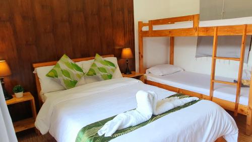 a bedroom with two bunk beds with towels on them at The Farm Shack by SMS Hospitality in Amadeo