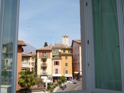 a view from a window of a city with buildings at Hotel Alpino in Malcesine