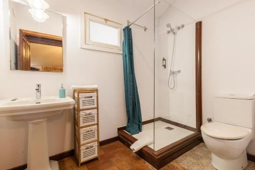 a bathroom with a sink toilet and a shower at Masia Notari Casabona in Vilanova i la Geltrú