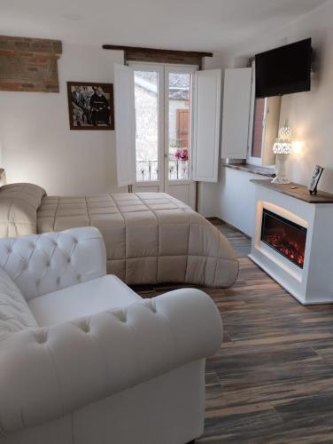 a living room with a couch and a fireplace at Dimora Forgione B&B - Pietrelcina in Pietrelcina