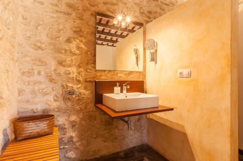 a bathroom with a sink and a mirror at Masia Notari Casabona in Vilanova i la Geltrú