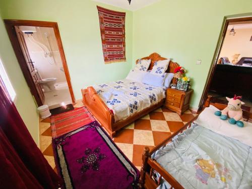 a bedroom with a bed and a mirror at Motel Ain Mersa in Ifrane