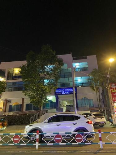 a white car parked in front of a building at Hung Vuong Hotel in Pleiku