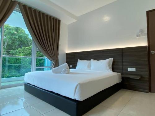 a bedroom with a large bed with a large window at 110 Home Sleep Home Kuah Langkawi in Kuah