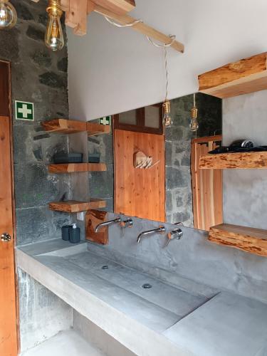 a kitchen with two faucets on the wall at Avó da Rosa 3 in Povoação
