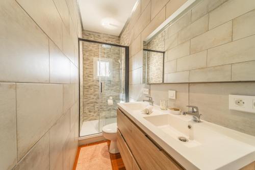 a bathroom with a sink and a toilet and a shower at Appartements à la ferme in La Ciotat