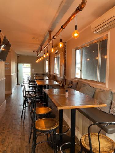a row of tables and chairs in a restaurant at The Light Horse Hotel in Harden