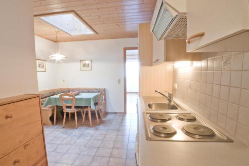 a kitchen with a sink and a table with a dining room at Haslbauer in Steinbach am Attersee