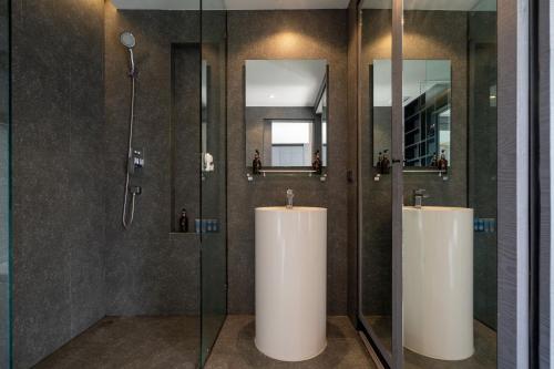 a bathroom with two sinks and a shower at Tropics Kamala 2BR Pool View Apartment CTG B705-6 in Kamala Beach