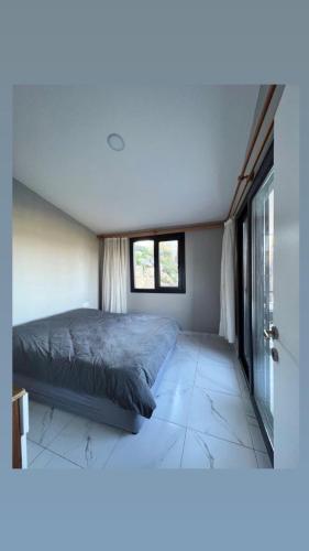 a bedroom with a bed and a window at Olympos Bungalov & Villa in Dalaman