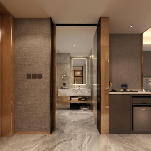 a bathroom with a sink and a counter with a mirror at Guangzhou Southern Airlines Pearl Airport Hotel- Free shuttle bus to airport in Guangzhou