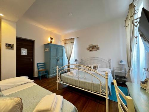 a bedroom with two beds and a blue cabinet at Palmasera Bed & Breakfast in Cala Gonone