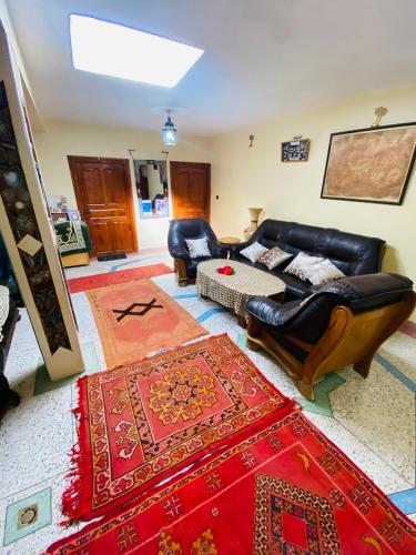 a living room with a couch and chairs and a rug at Motel Ain Mersa in Ifrane