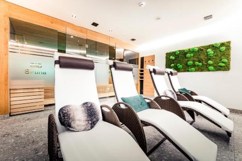 a waiting room with chairs and a painting on the wall at Haus St Anton - SKI IN SKI OUT in Sankt Anton am Arlberg