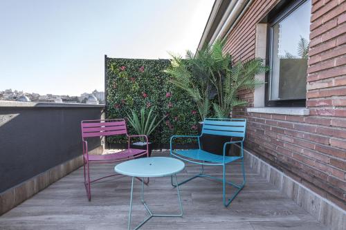 three chairs and a table on a balcony at Hotel Acta Madfor in Madrid