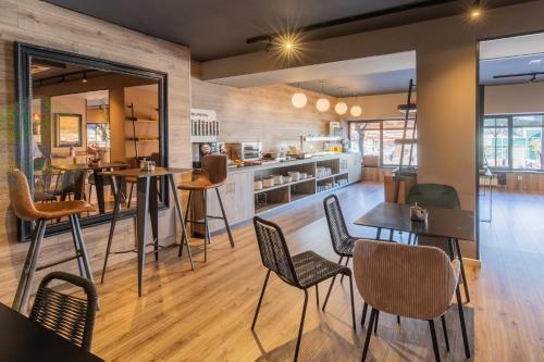 a restaurant with tables and chairs in a room at Hotel Acta Madfor in Madrid