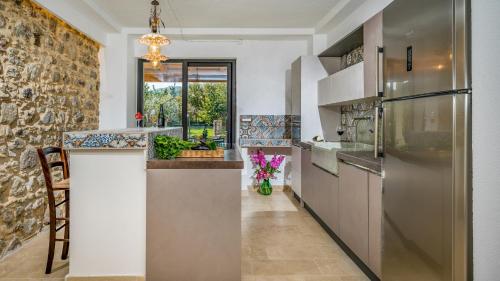 a kitchen with a stone wall at VILLA GALLUS 6, Emma Villas in Taormina