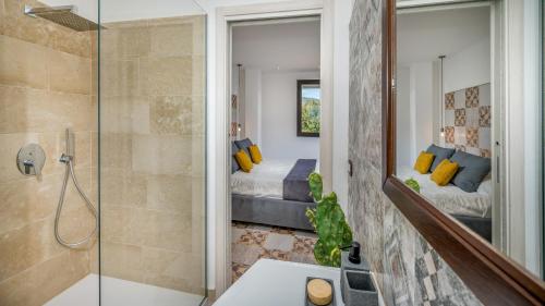 a bathroom with a shower and a bedroom with two beds at VILLA GALLUS 6, Emma Villas in Taormina