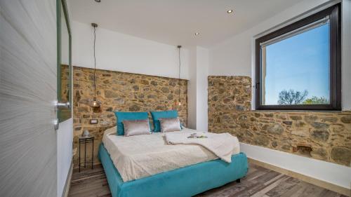 a bedroom with a blue bed and a window at VILLA GALLUS 6, Emma Villas in Taormina