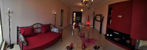 a living room with a red couch in a room at Lemnos Luxury Apartment in Mirina