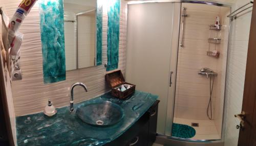 a bathroom with a green sink and a shower at Lemnos Luxury Apartment in Mirina