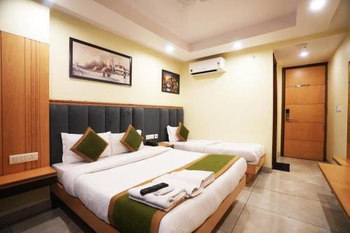 a hotel room with two beds in a room at Hotel Aman Imperial Near New Delhi Railway Station in New Delhi
