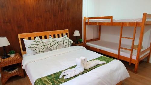 a bedroom with two beds and a bunk bed at The Farm Shack by SMS Hospitality in Amadeo