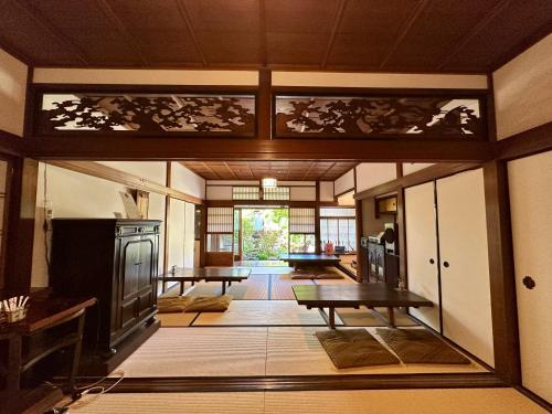 a living room with a table and a fireplace at Inase Otsu Machiya Bed and Breakfast in Otsu