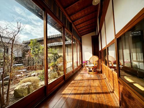 a hallway of a house with large windows at Inase Otsu Machiya Bed and Breakfast in Otsu