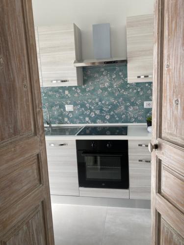a kitchen with a sink and a stove at Soffio del Salento in Matino