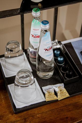 two bottles of water on a tray on a table at Casa Isolani Charms Rooms Santo Stefano in Bologna