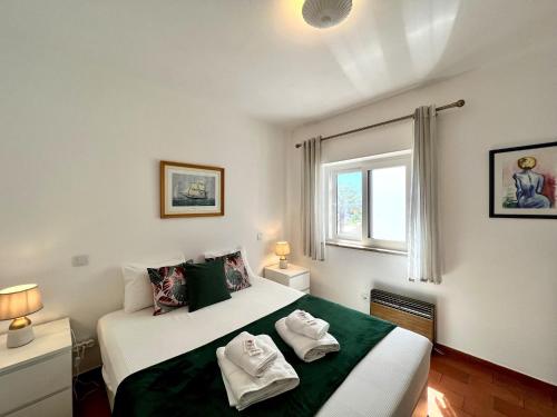 a bedroom with two beds with towels on them at Lagos Ocean Breeze by Homing in Lagos